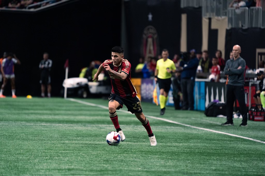 Thiago Almada dribbling forward