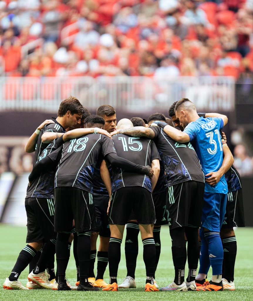 Atlanta United players huddling before the match