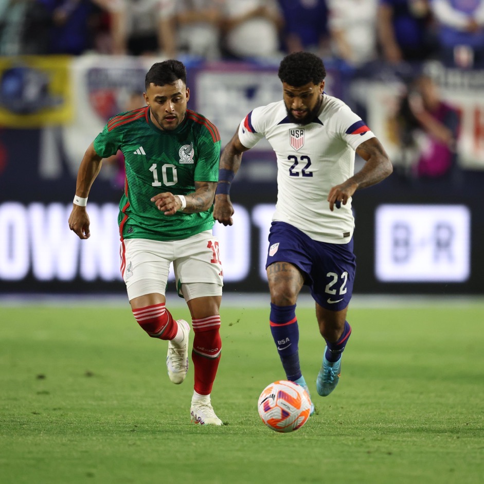 yedlin dribbling the ball with alexis vega at his back