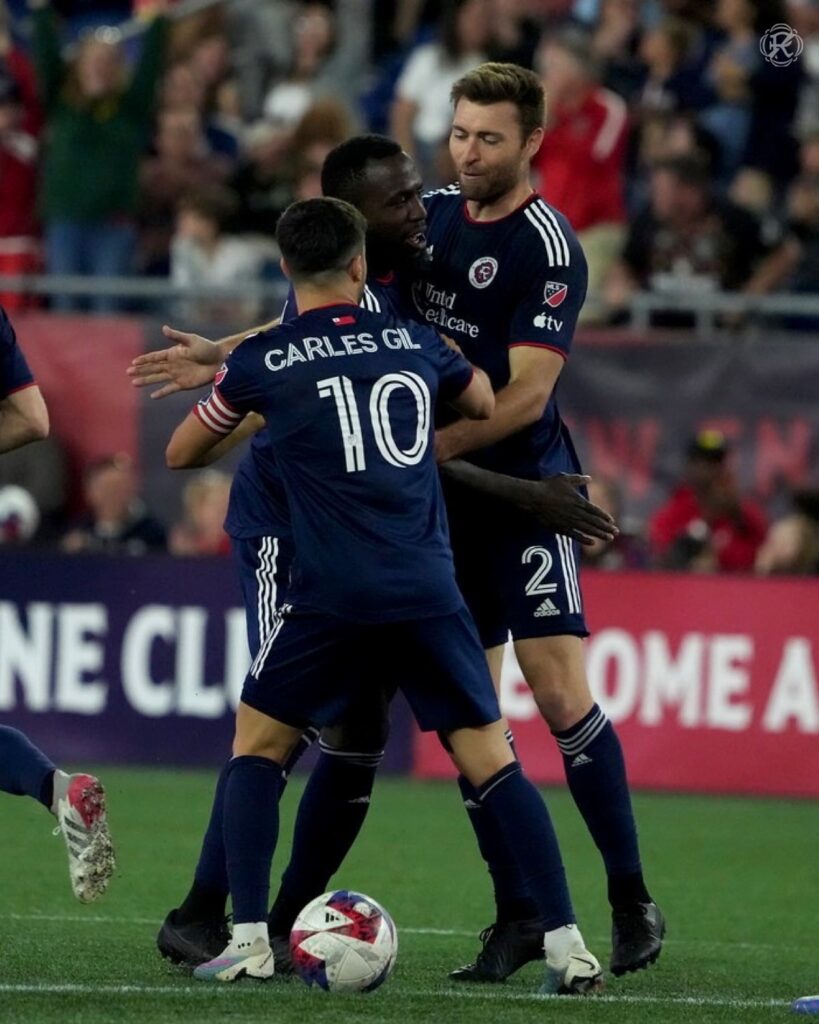 new england players celebrating a goal
